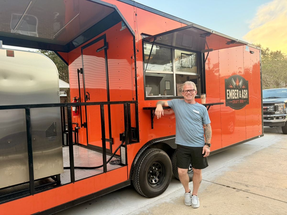 Johnny, pitmaster and owner, with the Ember & Ash Craft BBQ trailer