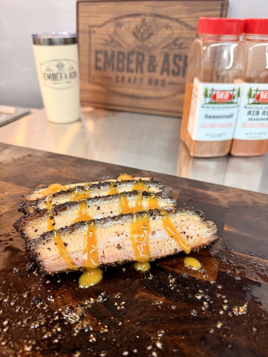 Sliced smoked pork belly drizzled with honey mustard BBQ sauce