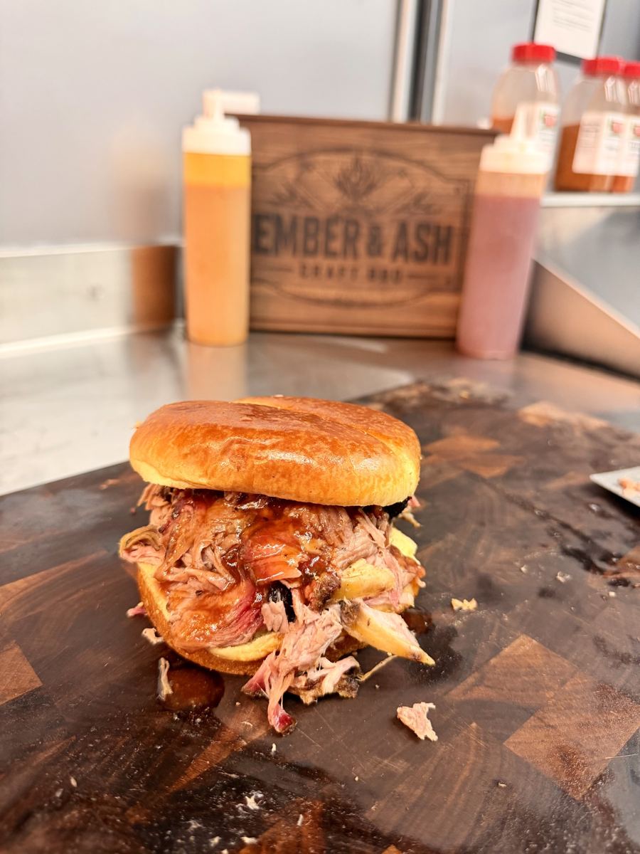 Pulled pork sandwich piled high on a toasted bun