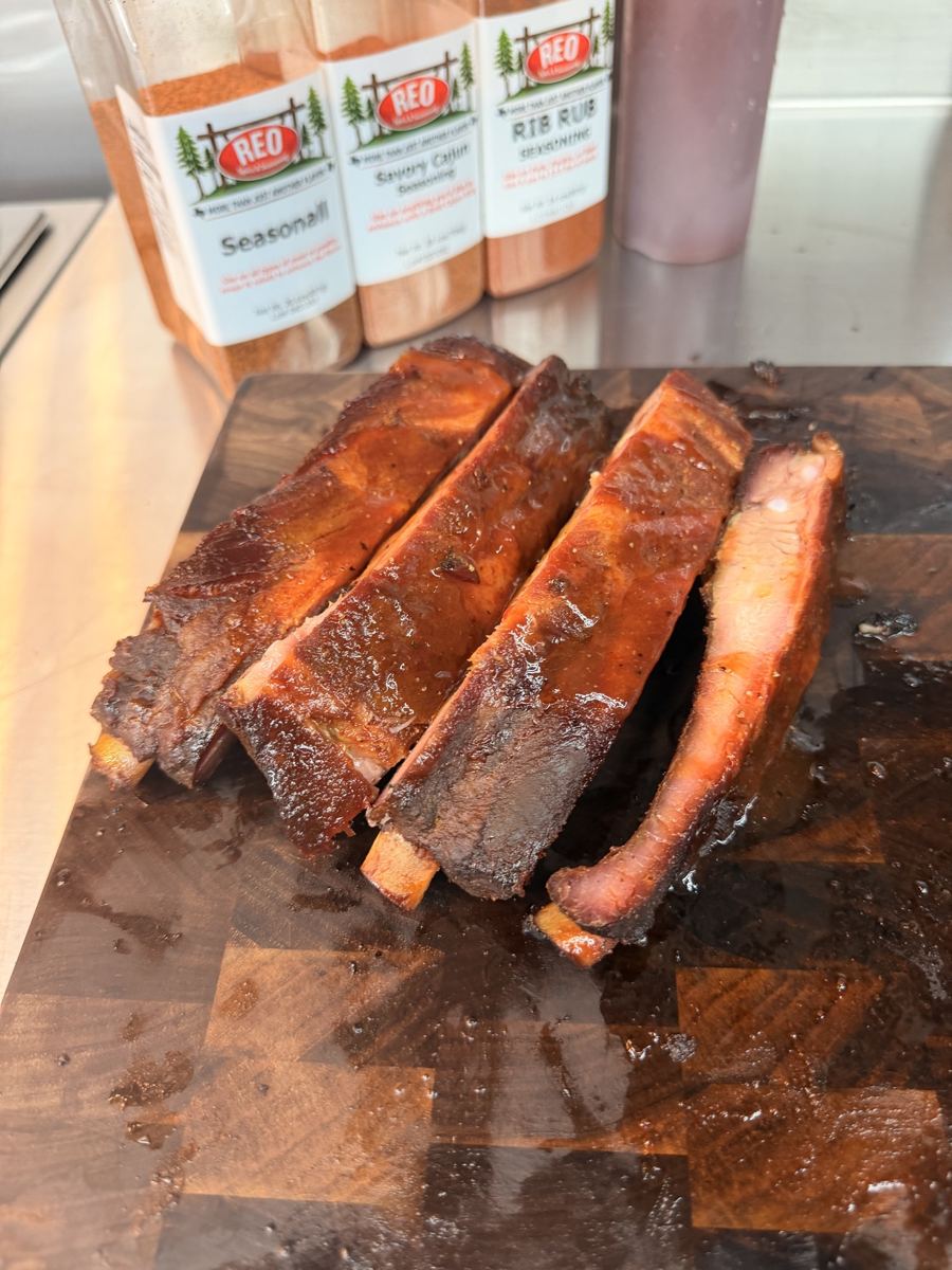Smoked spare ribs cut and lined up on a cutting board